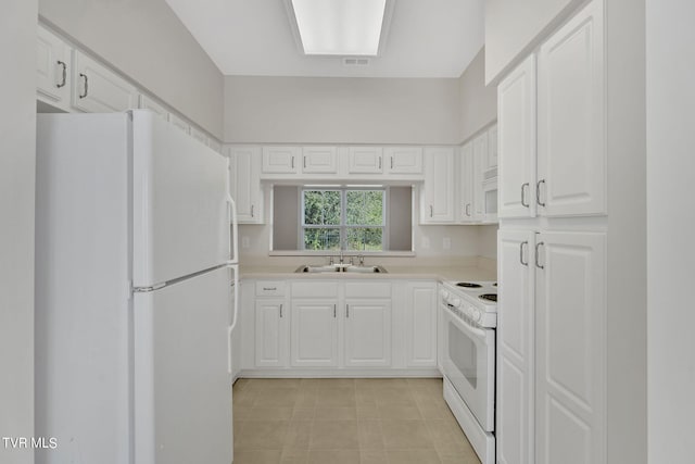 kitchen with white cabinetry, white appliances, and sink