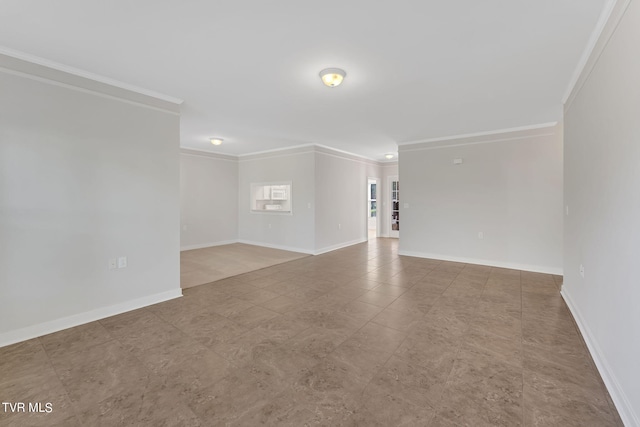 empty room featuring crown molding