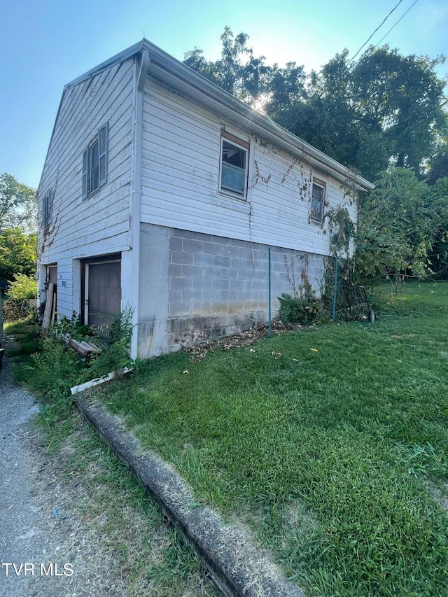 view of property exterior featuring a lawn and a garage