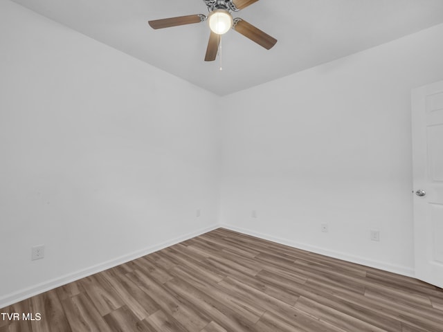 empty room featuring hardwood / wood-style floors and ceiling fan