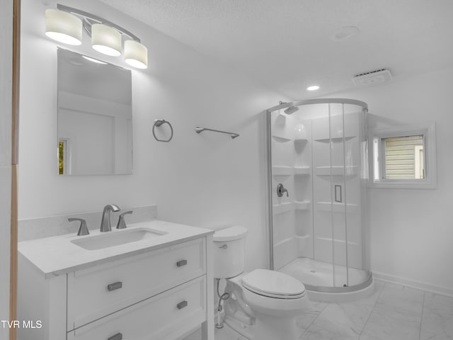 bathroom with vanity, a shower with shower door, and toilet