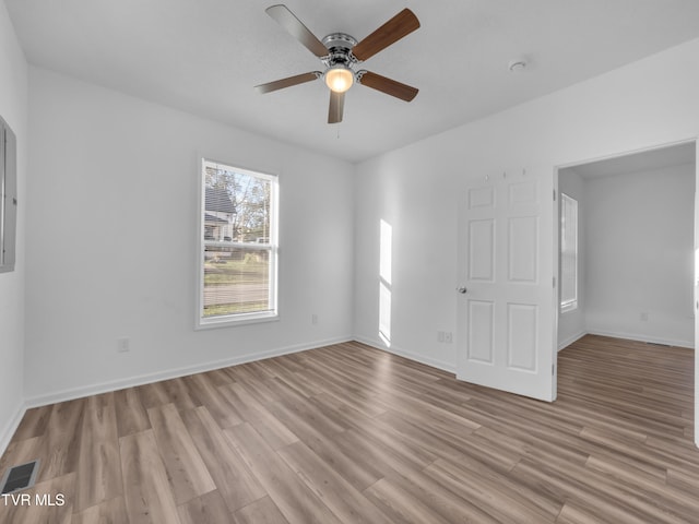 spare room featuring light wood-type flooring and ceiling fan