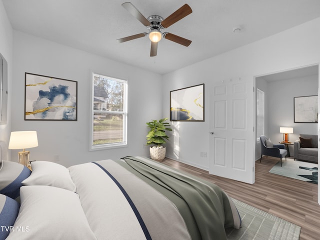 bedroom featuring hardwood / wood-style flooring and ceiling fan
