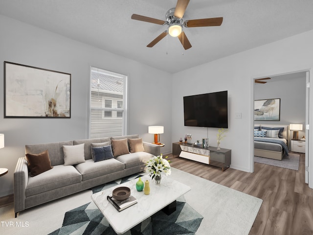 living room featuring ceiling fan and hardwood / wood-style floors