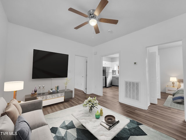 living room with dark hardwood / wood-style floors and ceiling fan