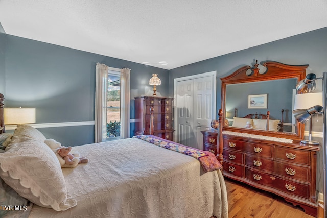 bedroom with a closet and light hardwood / wood-style flooring