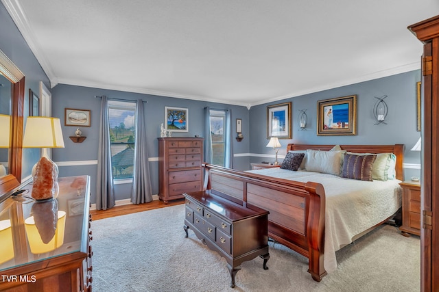 bedroom featuring ornamental molding and light hardwood / wood-style flooring