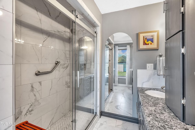 bathroom with a shower with door and vanity