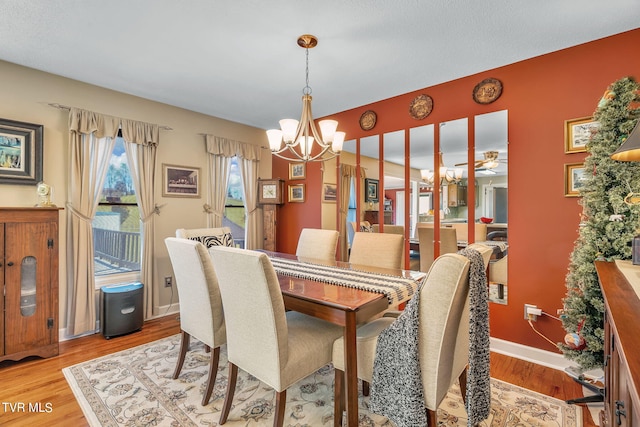 dining room with an inviting chandelier and light wood-type flooring