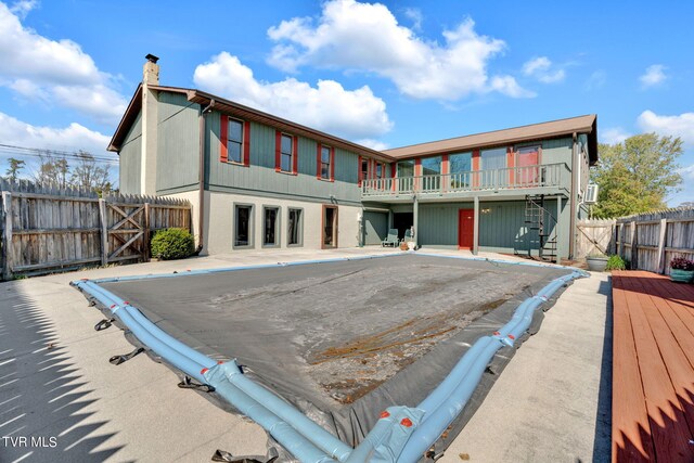 rear view of property featuring a balcony