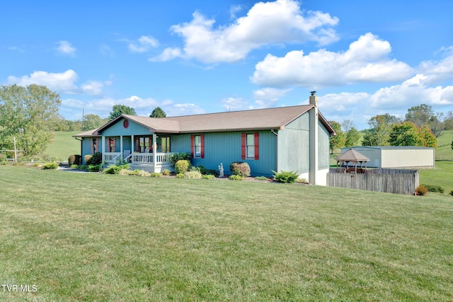 ranch-style house with a front yard and covered porch