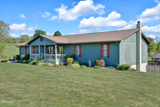 ranch-style home featuring covered porch and a front yard