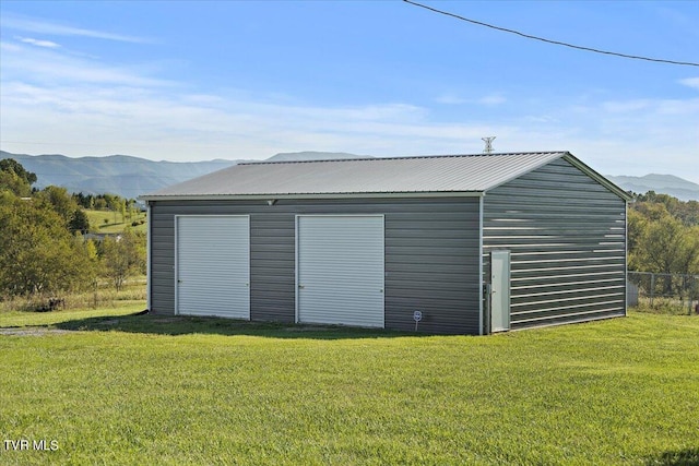 garage with a lawn and a mountain view