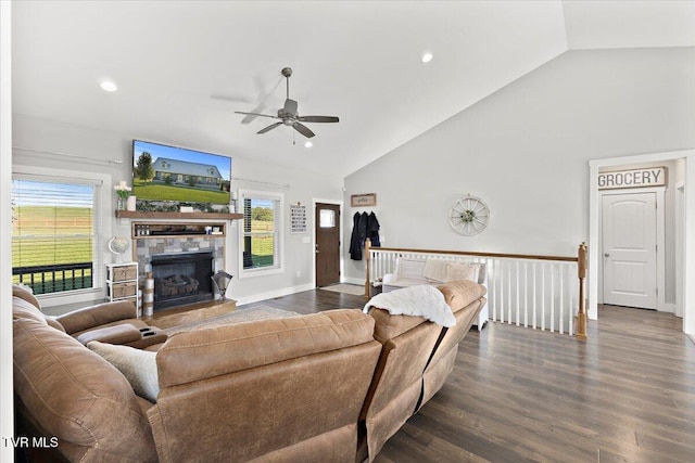 living room with dark wood-type flooring, plenty of natural light, a fireplace, and ceiling fan