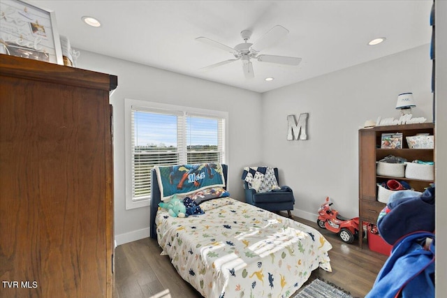 bedroom with ceiling fan and dark hardwood / wood-style floors