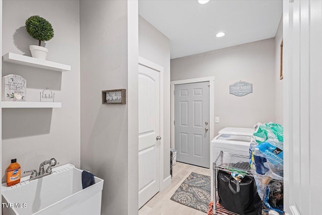 washroom featuring light hardwood / wood-style floors and sink