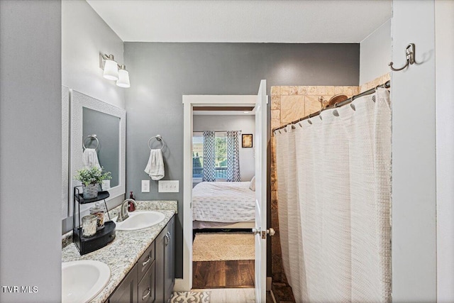 bathroom with a shower with curtain, vanity, and hardwood / wood-style floors