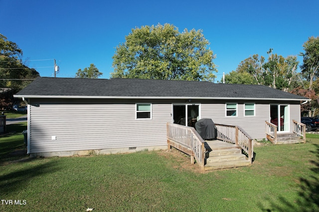 back of house with a deck and a yard