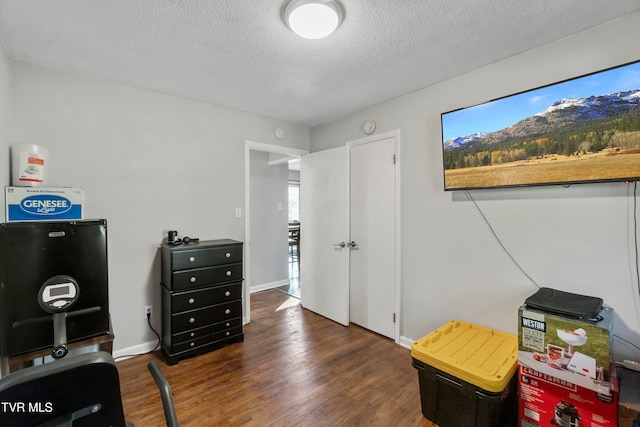 office area with a textured ceiling and dark hardwood / wood-style flooring