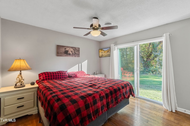 bedroom featuring access to exterior, ceiling fan, hardwood / wood-style floors, and a textured ceiling