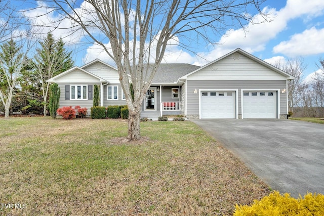 ranch-style home with covered porch, a garage, and a front lawn