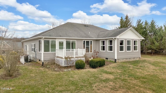 back of property featuring a yard, a deck, and central air condition unit