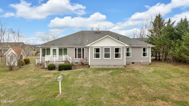 back of property featuring covered porch and a yard