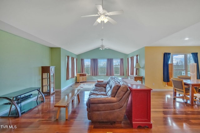 living room with hardwood / wood-style flooring, plenty of natural light, ceiling fan, and vaulted ceiling