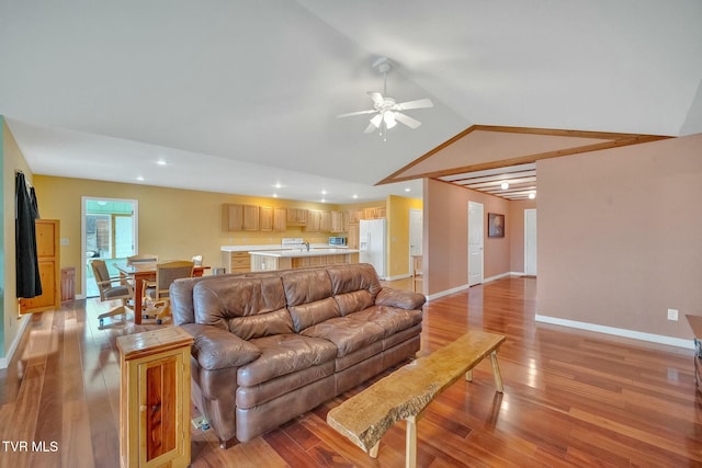 living room with ceiling fan, light hardwood / wood-style floors, and lofted ceiling