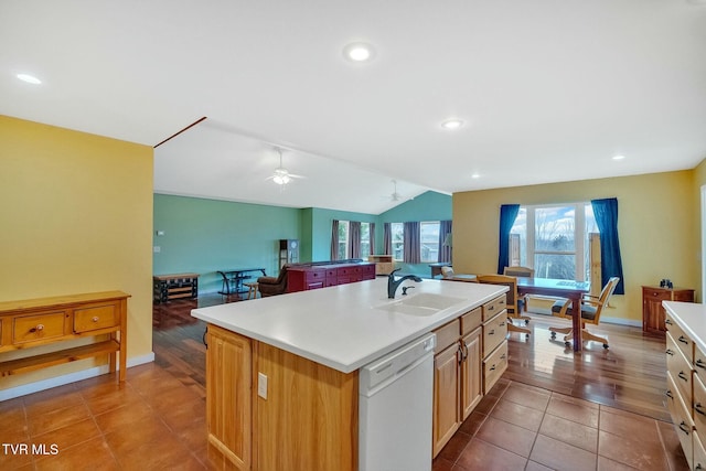 kitchen featuring white dishwasher, ceiling fan, sink, light tile patterned floors, and an island with sink