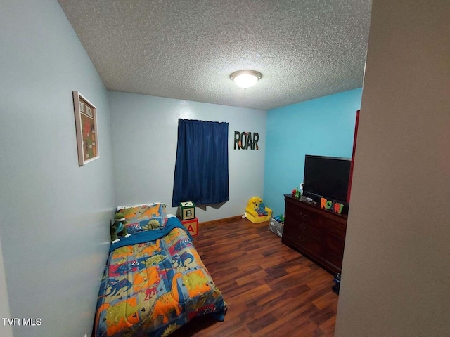 bedroom with dark hardwood / wood-style flooring and a textured ceiling