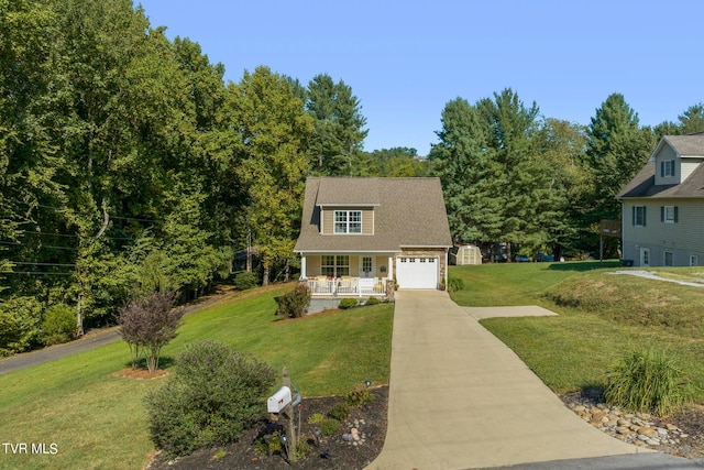 view of front of home featuring a garage, a front lawn, and covered porch