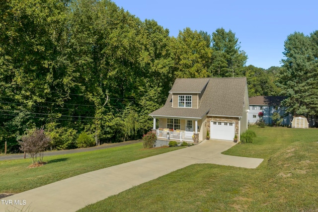 view of front of property featuring a front yard, a garage, a storage shed, and a porch