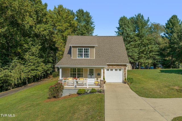 view of front of property featuring a front yard, a garage, and a porch