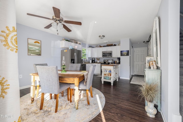 dining room with ceiling fan and dark wood-type flooring