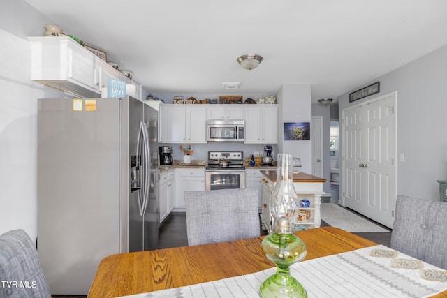 kitchen featuring stainless steel appliances and white cabinets