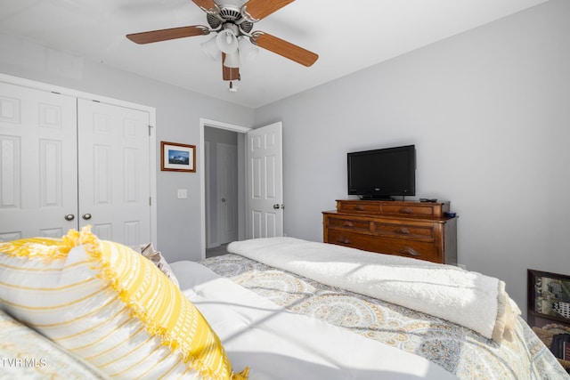 bedroom featuring ceiling fan and a closet