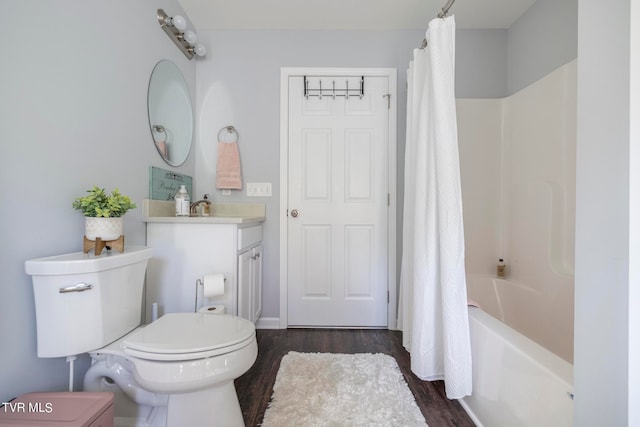 full bathroom featuring shower / bath combination with curtain, hardwood / wood-style flooring, vanity, and toilet