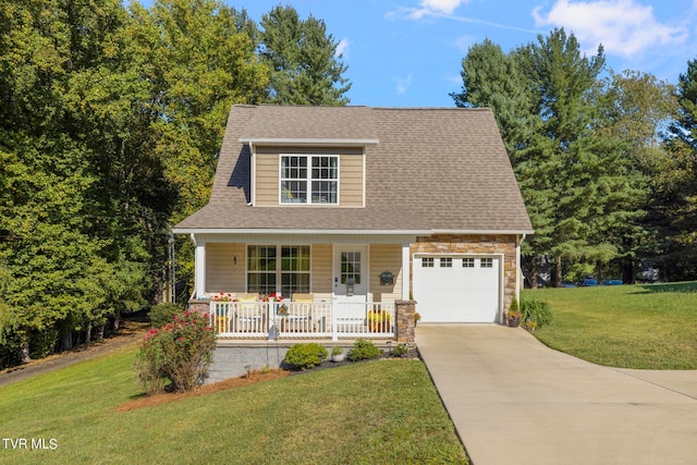 view of front of property with a front yard, a garage, and a porch