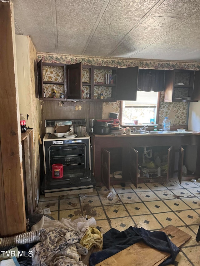 kitchen featuring dark brown cabinets and a textured ceiling