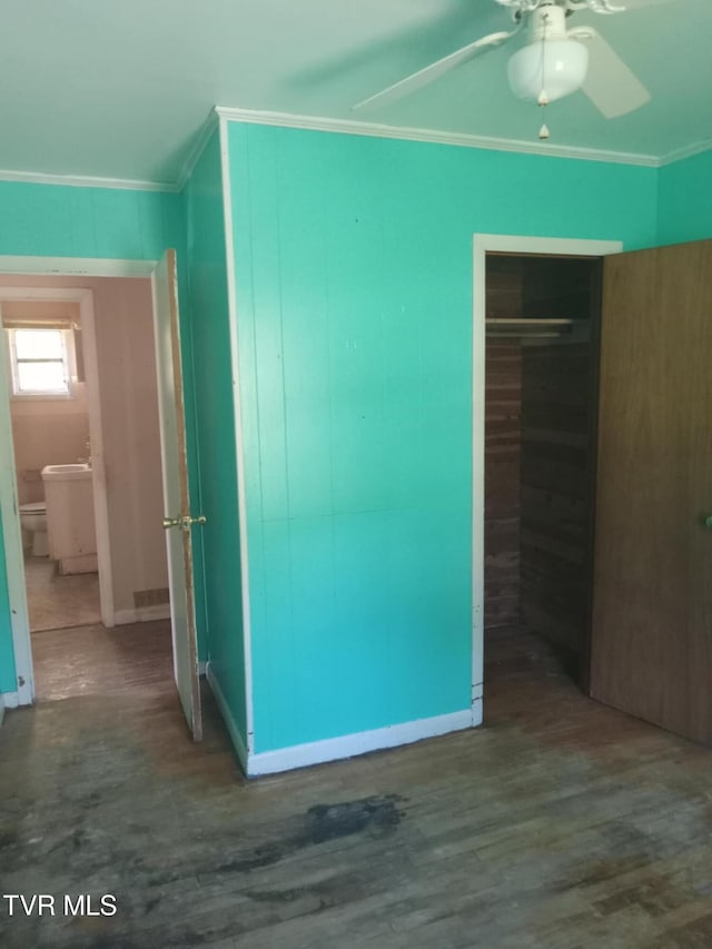 interior space featuring ornamental molding, ceiling fan, a closet, and wood-type flooring