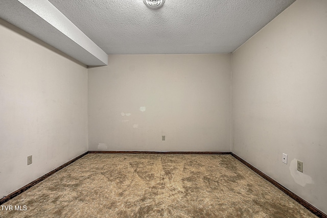 unfurnished room featuring a textured ceiling and carpet floors