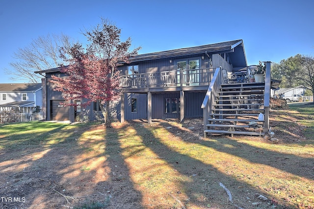 rear view of house featuring a lawn and a deck