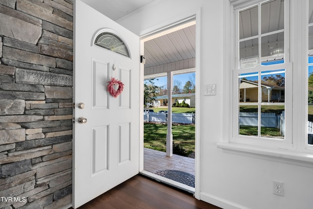 interior space featuring ornamental molding and dark hardwood / wood-style floors