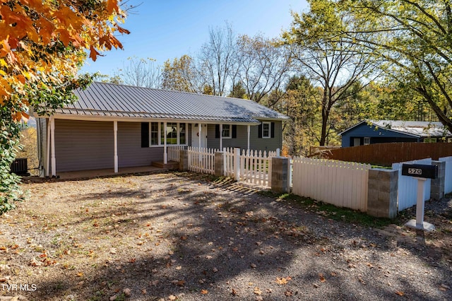 ranch-style house featuring cooling unit and covered porch