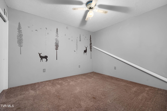 spare room with carpet, a textured ceiling, and ceiling fan