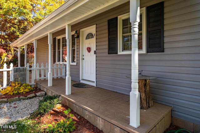 view of exterior entry featuring a porch