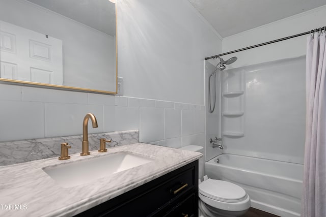 full bathroom with shower / bath combo, toilet, tile walls, vanity, and crown molding