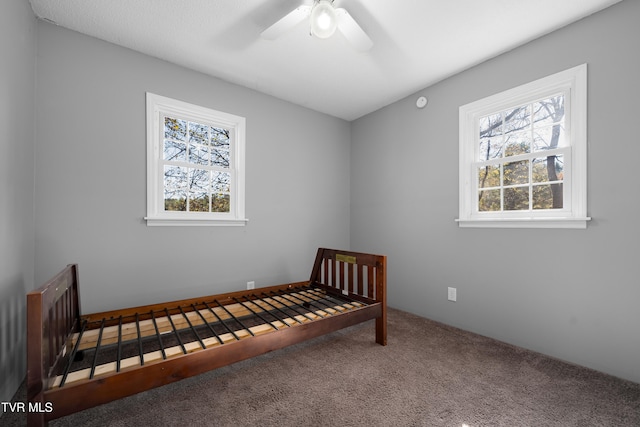 carpeted bedroom featuring ceiling fan