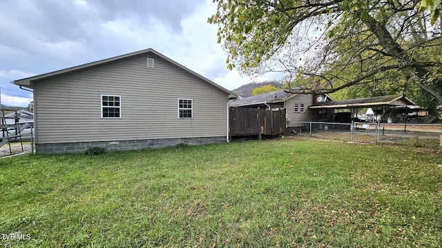 view of side of property with a lawn